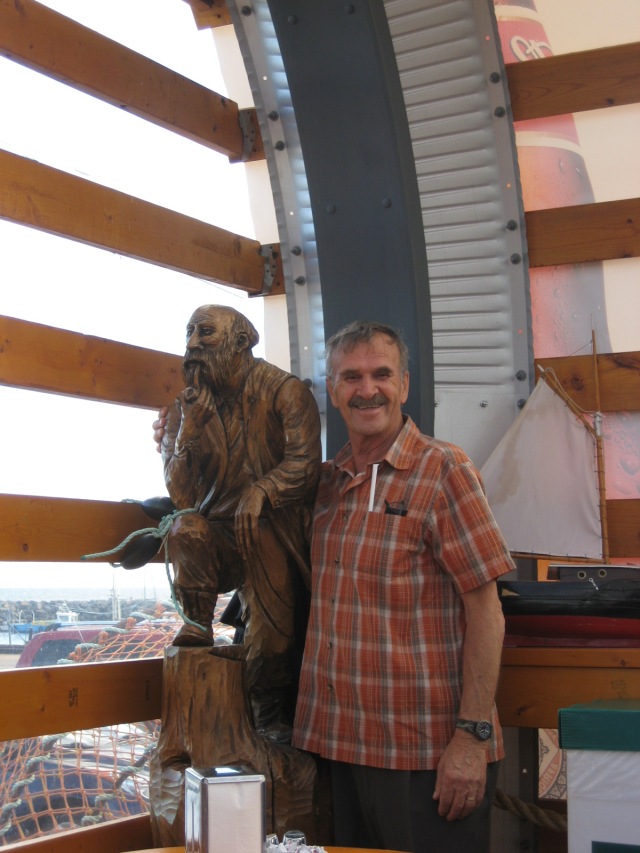 Andre posing with one of the lovely carved figures at the Casse-Croûte on the wharf in Sept-Îles, Quebec